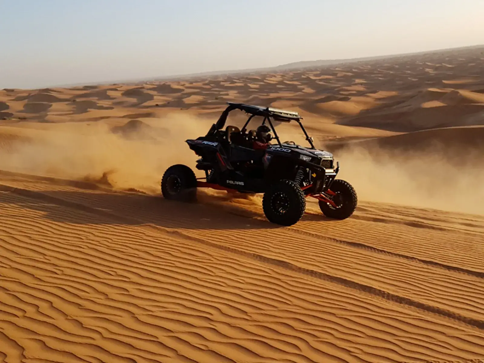 Dune buggy sliding across soft sand