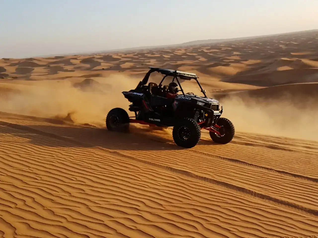 Dune buggy sliding across soft sand