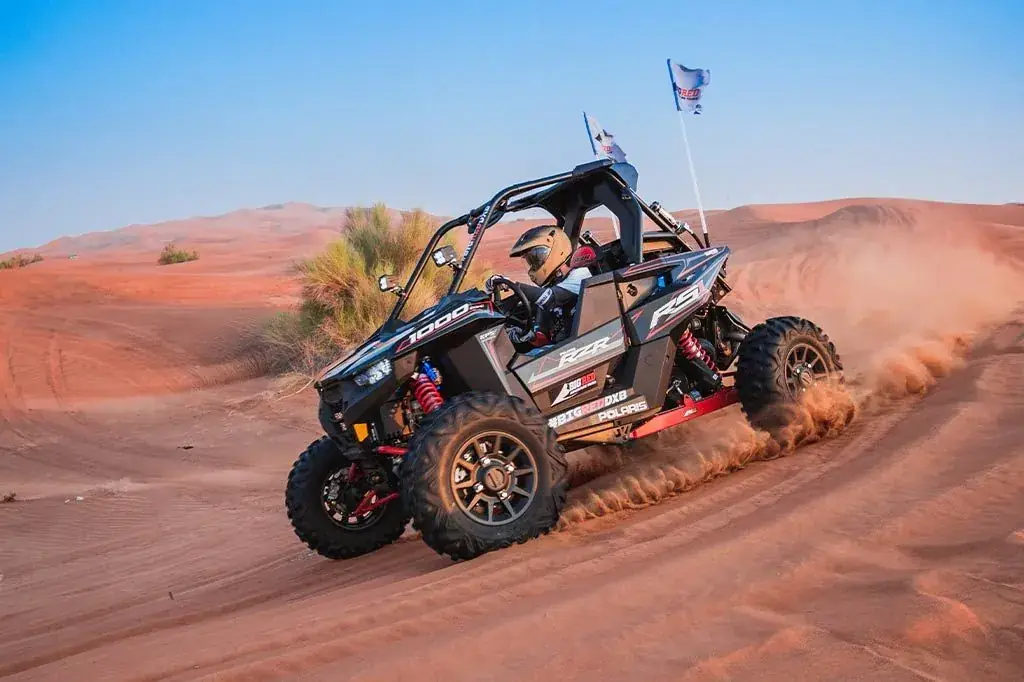 Buggy throwing sand as it turns