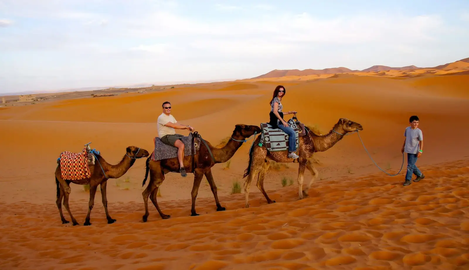 Family camel caravan in the Merzouga dunes