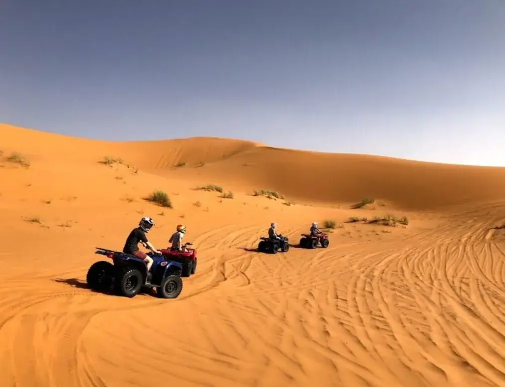 Row of luxury tents at Merzouga Glamping beside the dunes