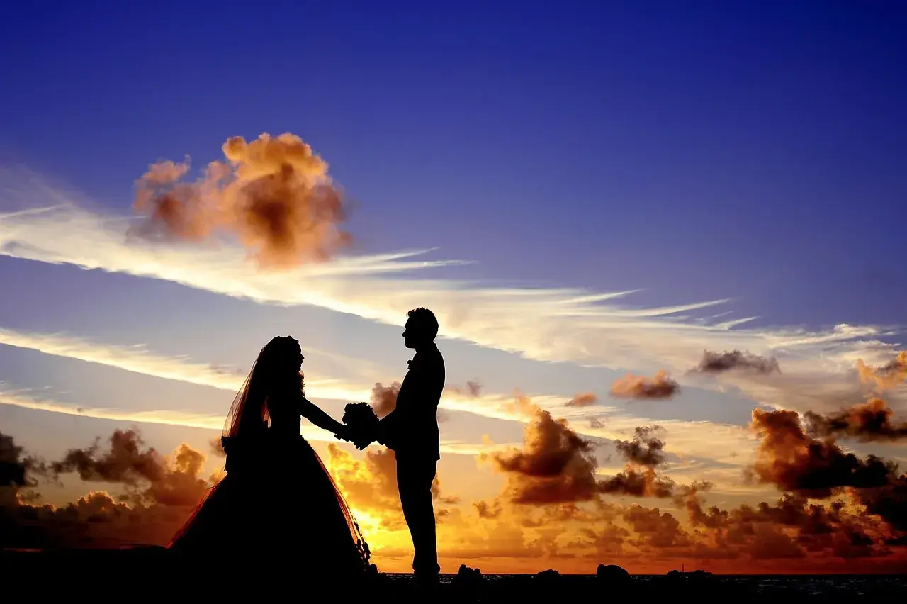 Couple silhouetted against a desert sunset