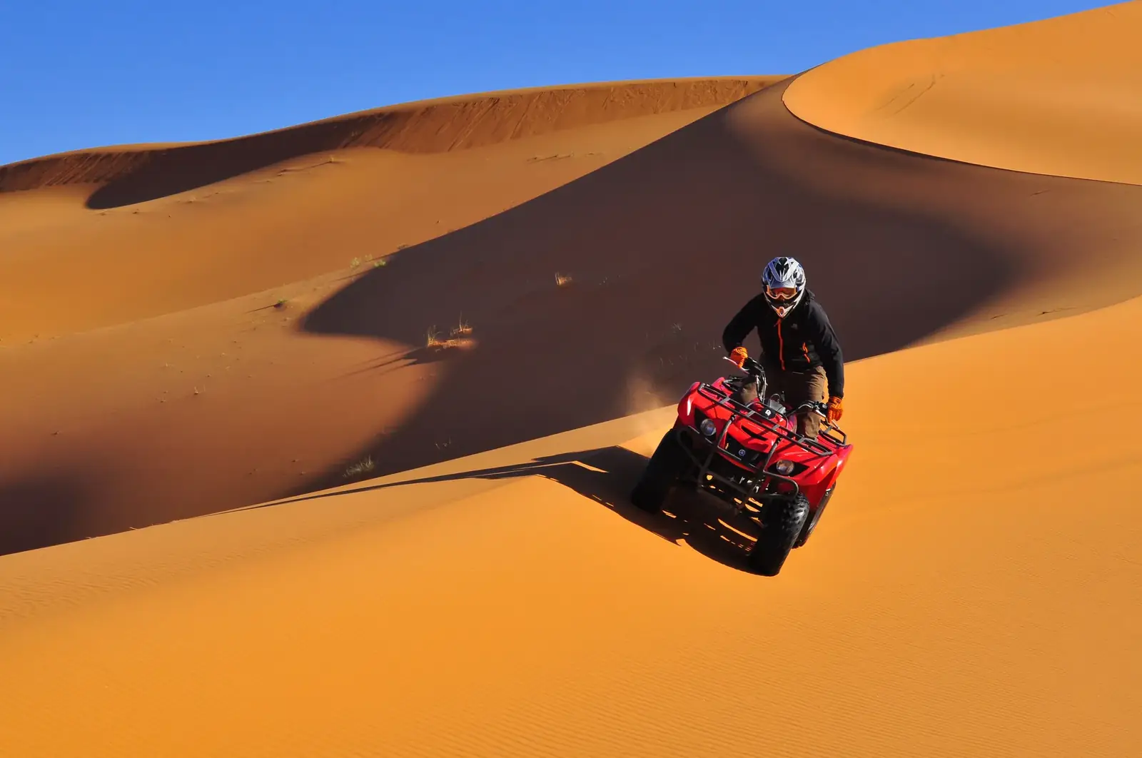 The golden dunes of Erg Chebbi under a clear sky near Merzouga