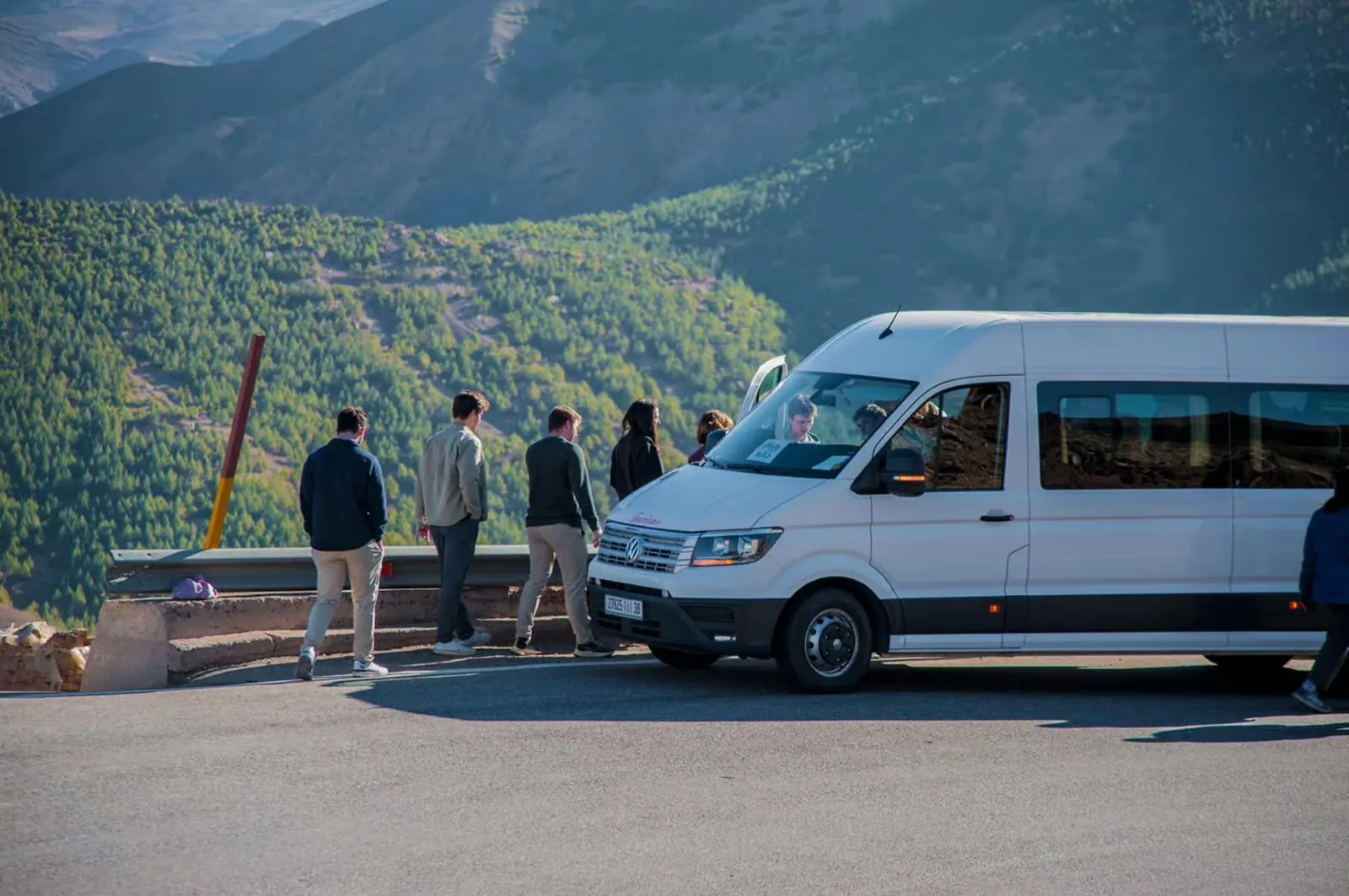 Travellers beside a transfer minibus in Morocco