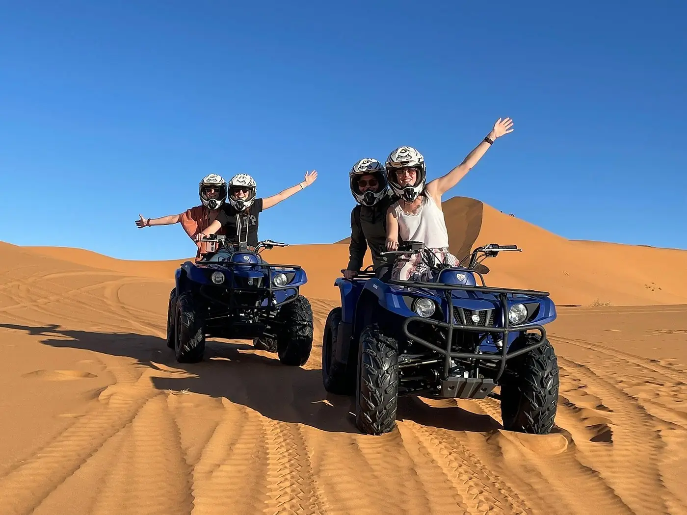 Guests riding automatic quad bikes across the Erg Chebbi dunes near Merzouga
