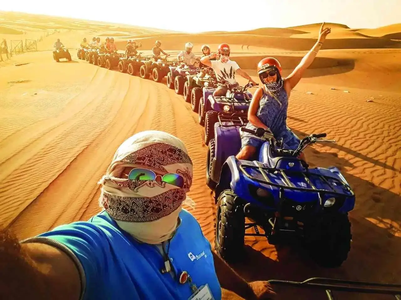 Group of quad bikes lined up on the dunes near Merzouga