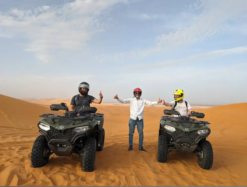 Quad biking group with guides on the Merzouga dunes