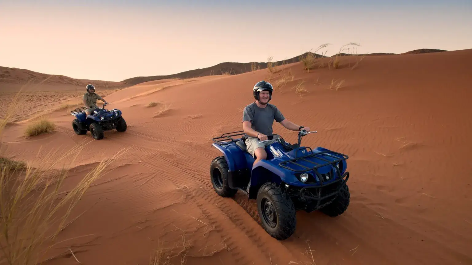 Quad bike riders crossing the sand