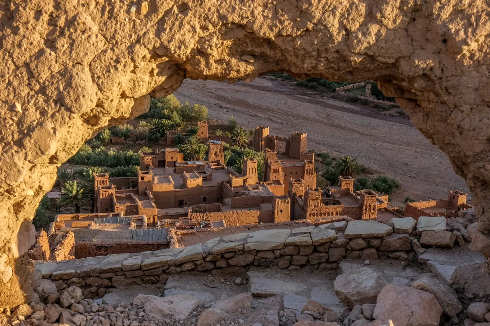 The kasbah of Aït Benhaddou seen through a rocky arch