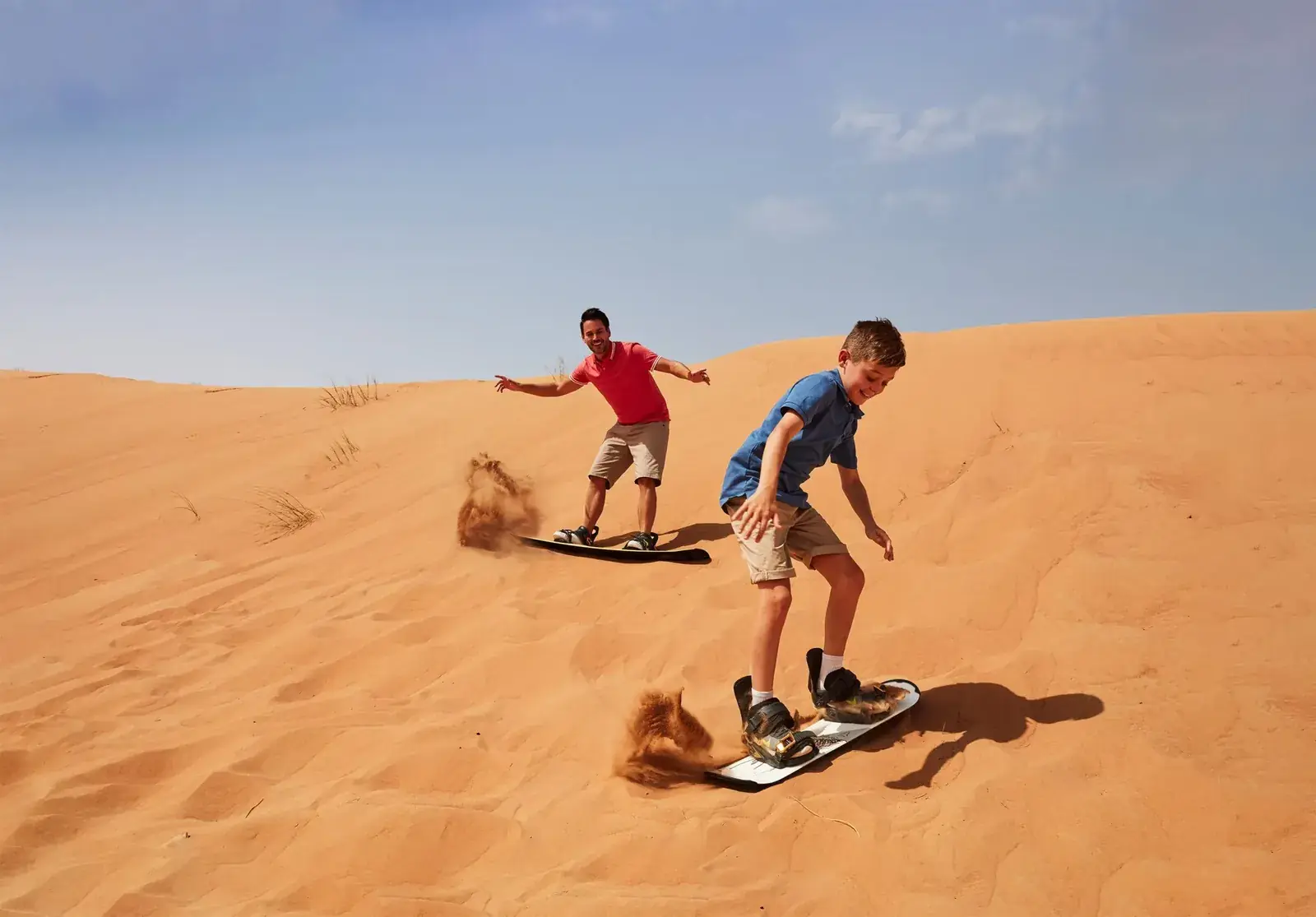 Children sandboarding at Merzouga