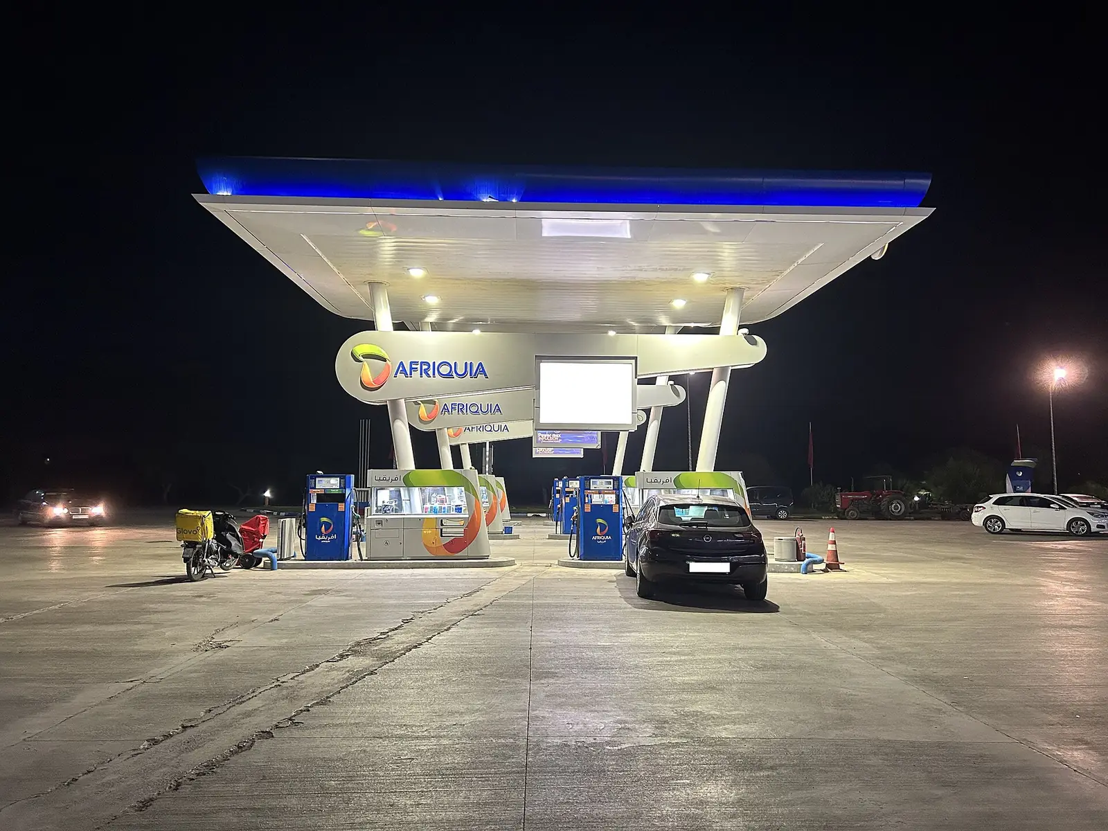 An Afriquia petrol station lit up at night in Morocco