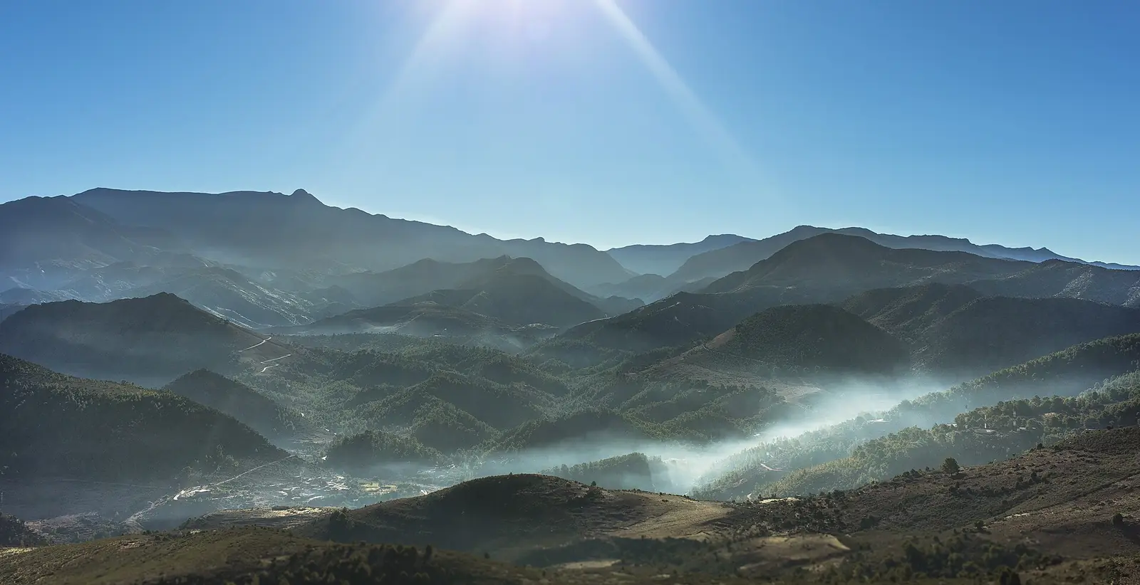 Misty mountain valleys seen from the road to Merzouga
