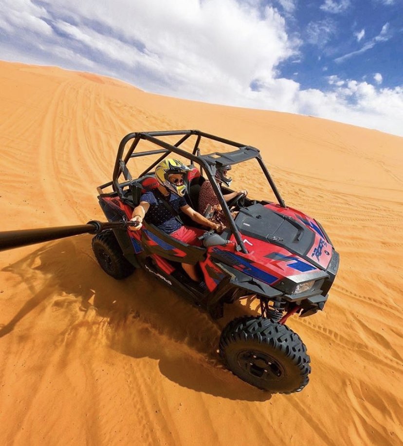 A go-pro image of 2 people riding a buggy