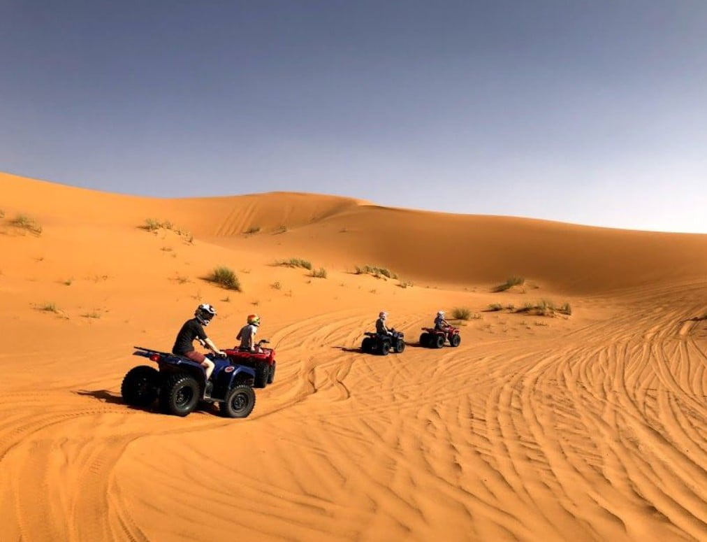 A group of people going on Atv quad bikes